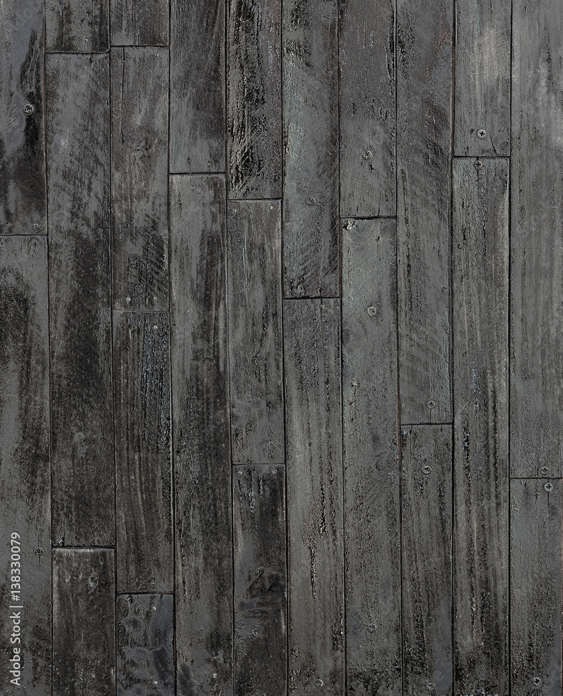 Painted wall paneling in black color,restoration of old wooden planks ...