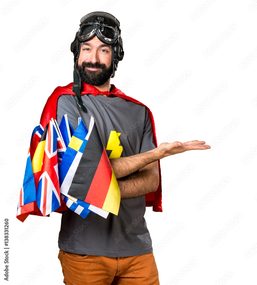 Superhero with a lot of flags presenting something Superhero with a lot of flags presenting something