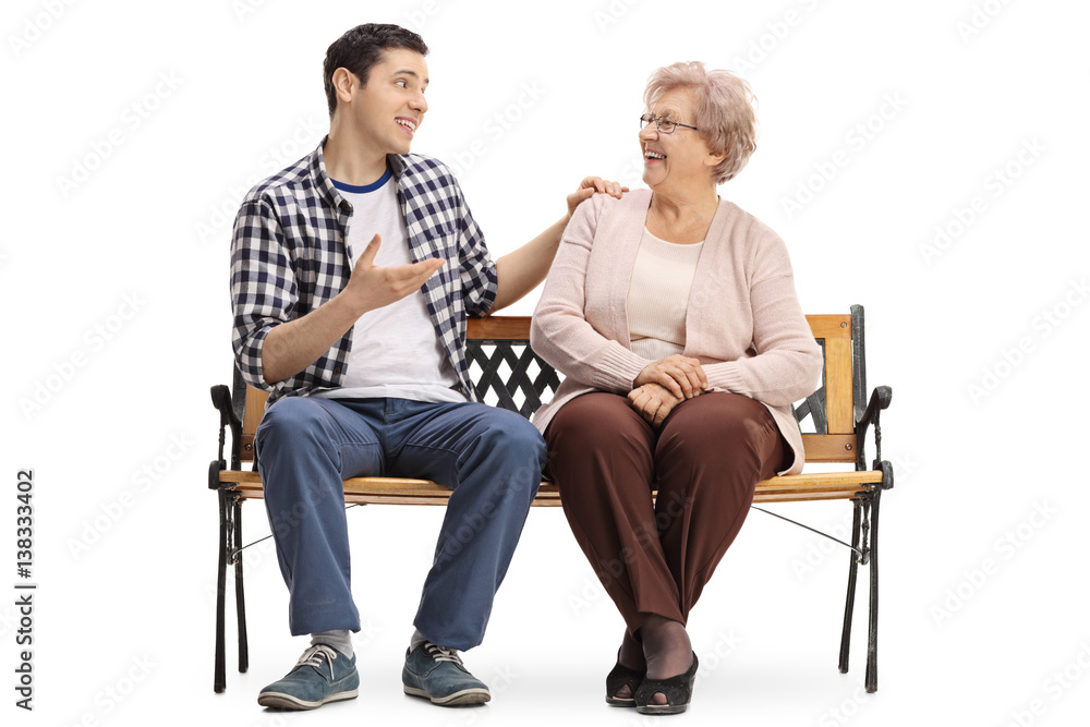 Young man and elderly woman sitting on bench and talking Young man and elderly woman sitting on bench and talking
