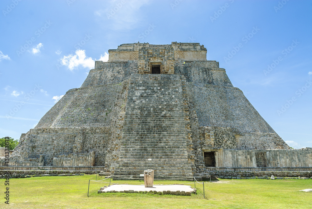 sight of the pyramid of the magician in the Mayan archaeological Uxmal enclosure in Yucatan, Mexico.