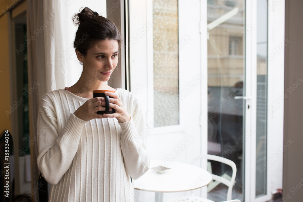 Smiling woman holding a cup Smiling woman holding a cup