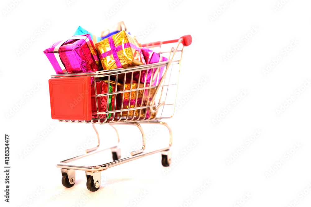 Shopping Cart with Christmas or New Year gifts boxes on isolated white