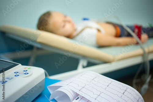 Electrocardiogram, cardiac cardiograph and conduct research in pediatrics, a girl doing an electrocardiogram