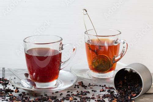 Black tea with spices.Strainer. Grey wooden background.