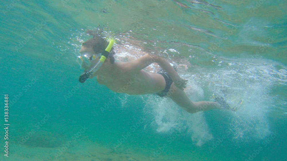 a boy snorkeling in the ocean