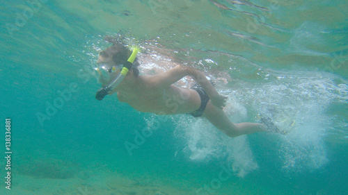 a boy snorkeling in the ocean