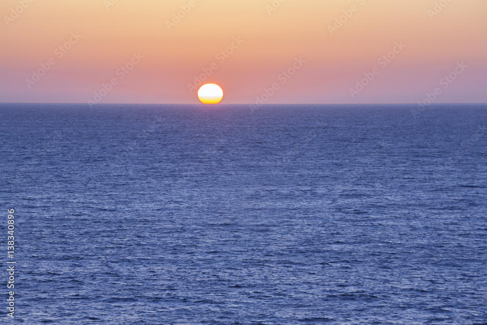 The Sun setting into the ocean