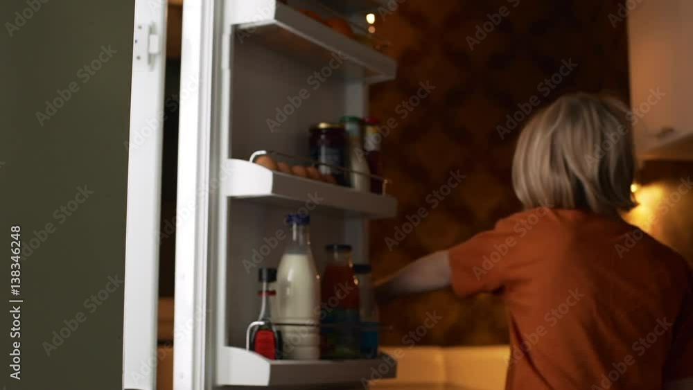 Young blonde kid taking bottle of yogurt from fridge than closing it in slowmotion Young blonde kid taking bottle of yogurt from fridge than closing it in slowmotion