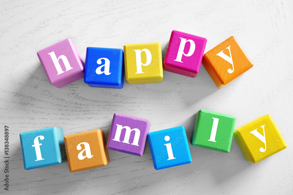Colorful cubes with text HAPPY FAMILY on wooden background Colorful cubes with text HAPPY FAMILY on wooden background