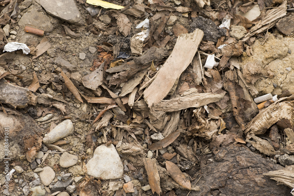 wood peeling and pebbles on the floor with cigarette butts wood peeling and pebbles on the floor with cigarette butts