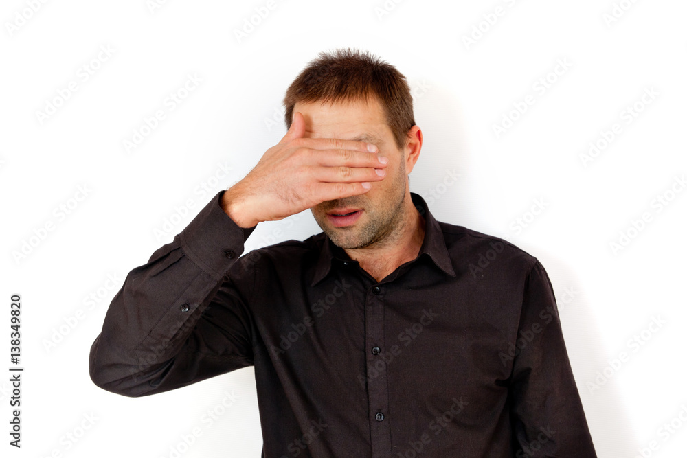 Young man covered his face with his hand Young man covered his face with his hand