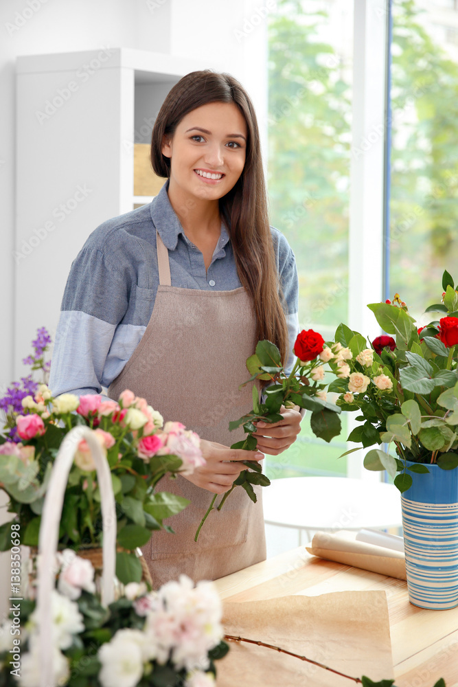 Pretty young florist at workplace