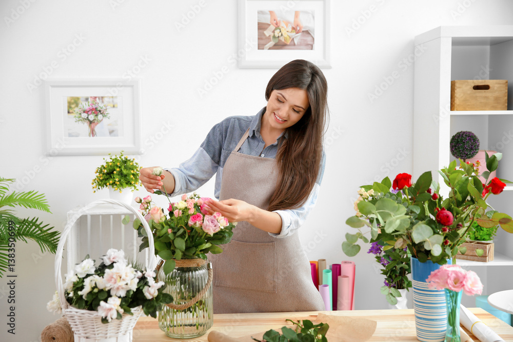 Pretty young florist at workplace