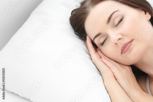 Closeup of young attractive woman sleeping in bedroom