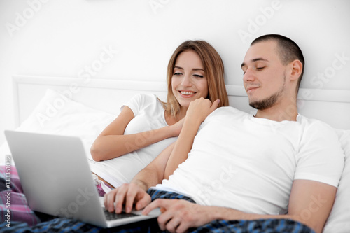 Young couple lying together in bed © Africa Studio