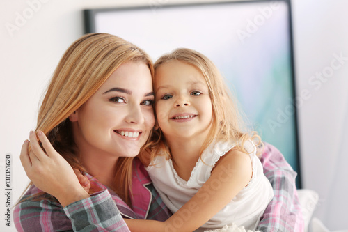 Happy young woman and her daughter at home. Mother's day concept