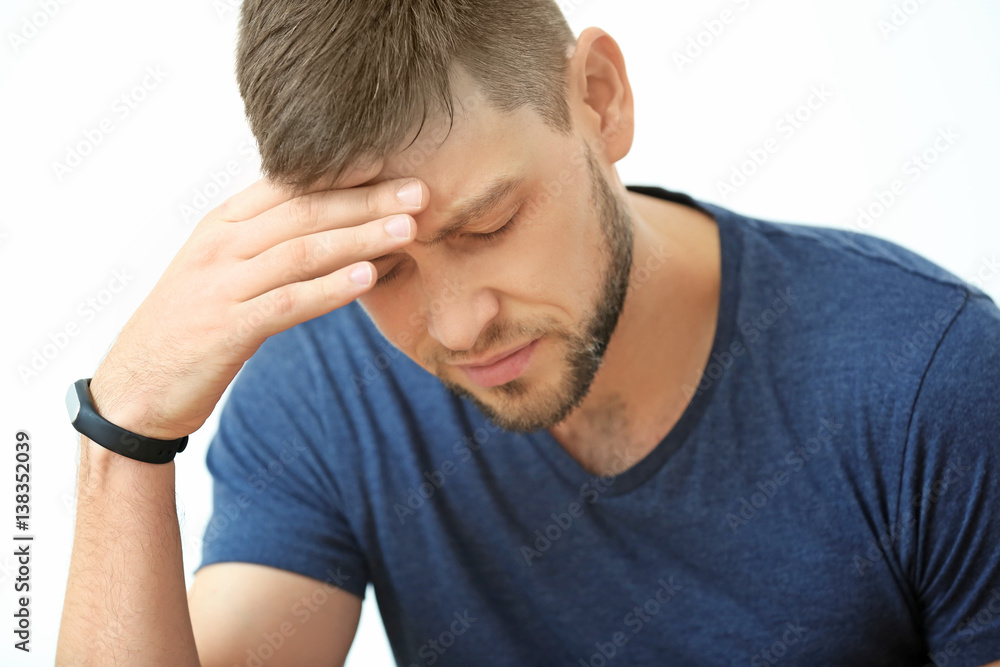 Handsome young man suffering from headache at home, closeup Handsome young man suffering from headache at home, closeup