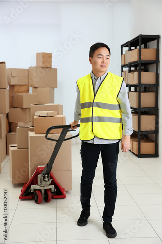 Man with loader at warehouse