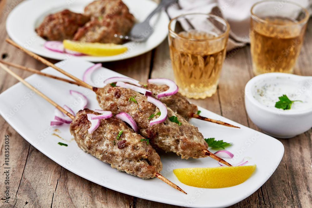 shish kebab from lamb meat with white sauce and wine.