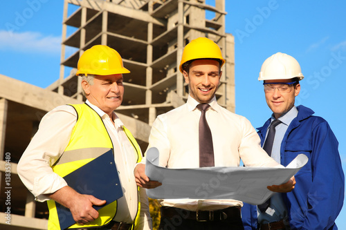 Engineer with drawing and w...