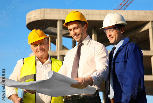 Engineer with drawing and w...