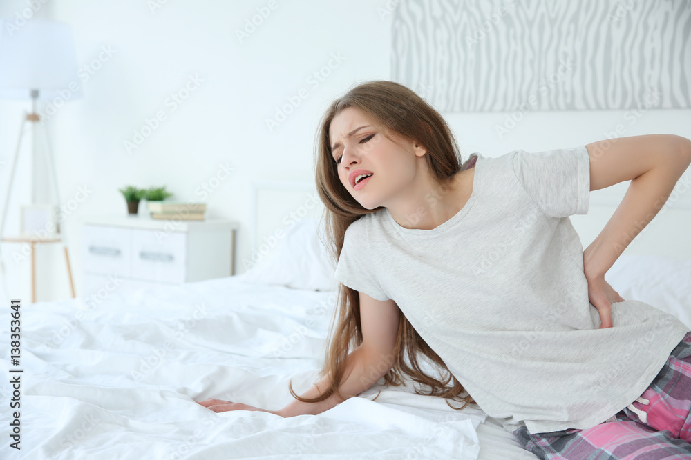Pretty woman feeling back pain at home Pretty woman feeling back pain at home