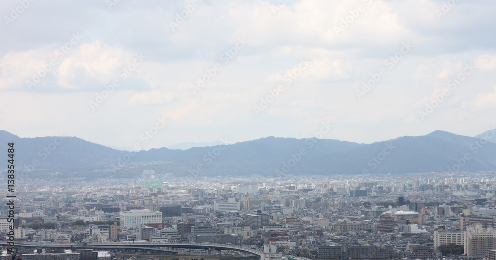 Panoramic image of the modern city at the foot of the mountain range