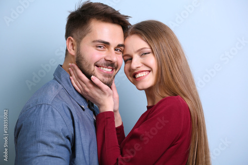 Cute young couple on color ...