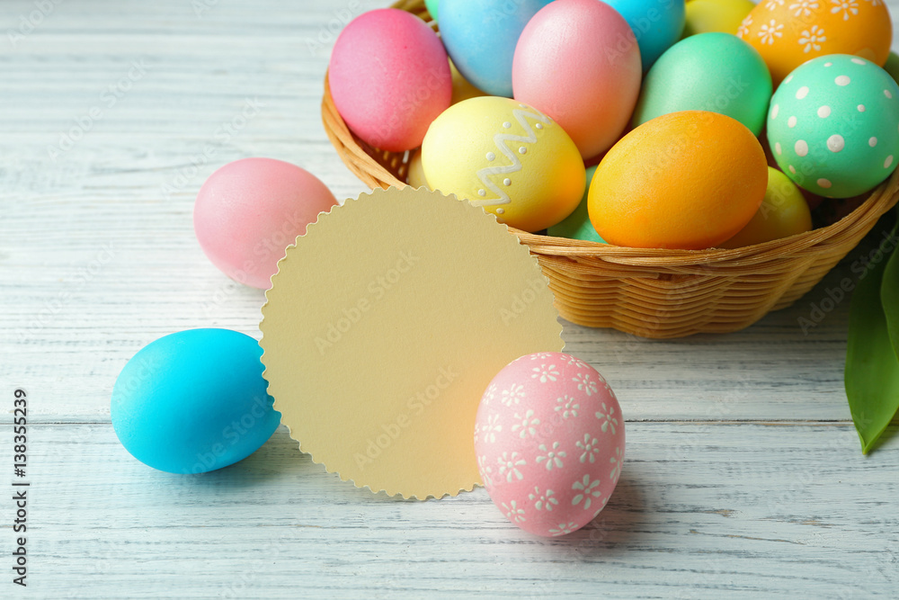 Easter eggs on wooden background with blank card Easter eggs on wooden background with blank card