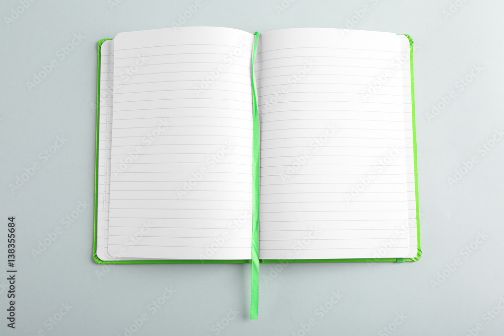 Opened notebook on grey background Opened notebook on grey background