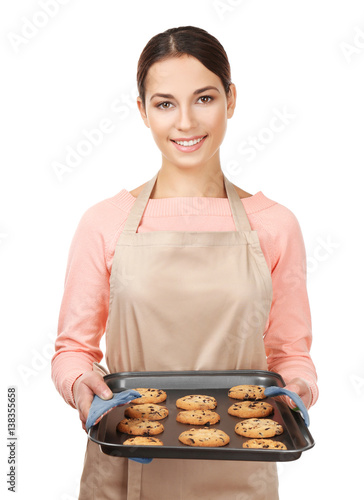 Young woman in apron holdin...