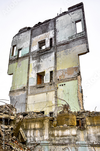 Pieces of Metal and Stone are Crumbling from Demolished Building © alisluch