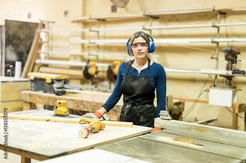 Attractive female carpenter at work