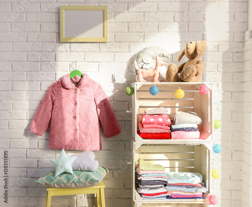 Clothes on shelf in kids room
