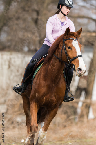 Young girl riding a horse