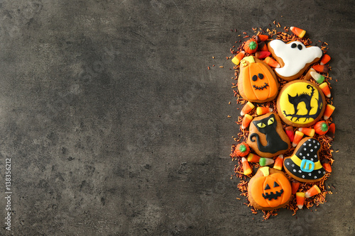 Halloween cookies and jelly sweets on dark background photo