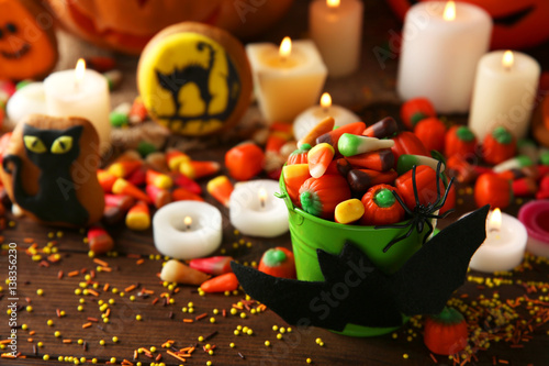 Halloween jelly sweets in bucket on wooden table photo