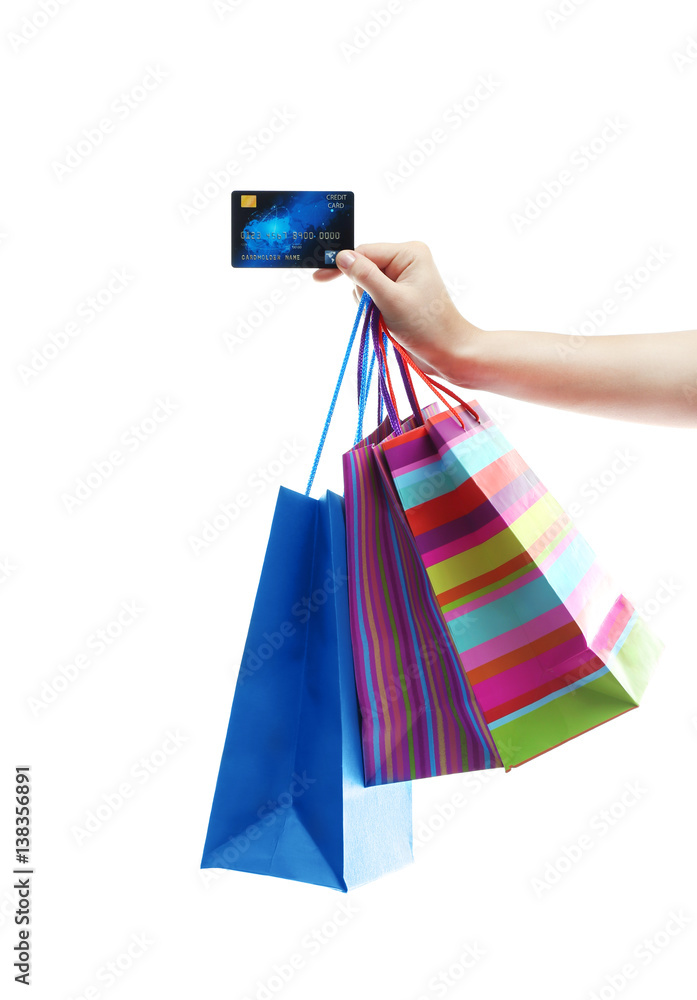 Woman holding shopping bags and credit card on white background