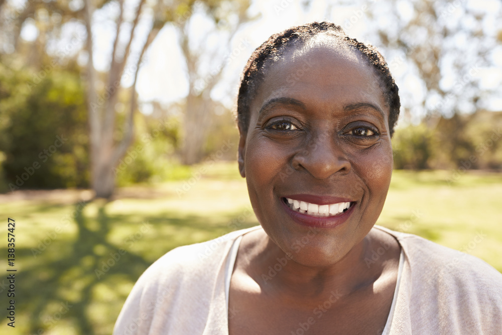Head And Shoulders Portrait Of Mature Woman In Park Head And Shoulders Portrait Of Mature Woman In Park