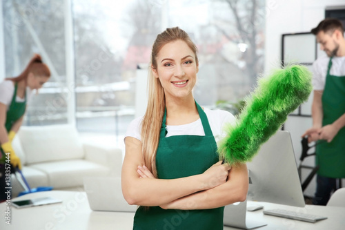 Young female cleaner at wor...