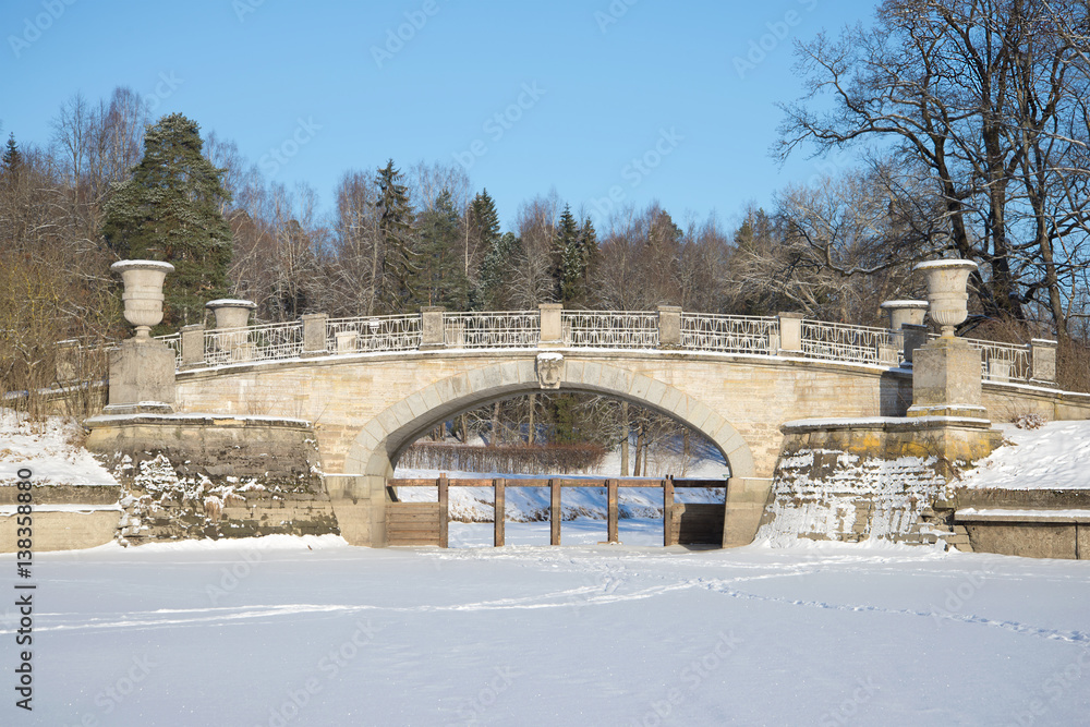 Old Viscontiev bridge closeup sunny February day. Pavlovsk palace park, a neighborhood of Saint Petersburg