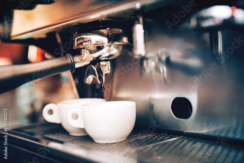 Professional coffee brewing. Espresso machine preparing and pouring two perfect cups of coffee. Restaurant details