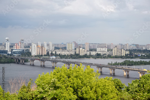 Kyiv. Ukraine. Paton Bridge and view of residential buildings on left Dnieper River bank.
