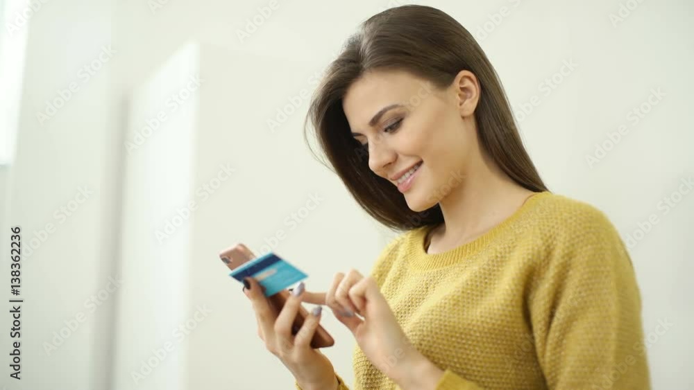 Teenager with telephone and bank card indoors. Beautiful woman shopping online with credit card and smartphone. Easy pay using smart phone or digital gadget and e-money. app for sale in shop. Teenager with telephone and bank card indoors. Beautiful woman shopping online with credit card and smartphone. Easy pay using smart phone or digital gadget and e-money. app for sale in shop.