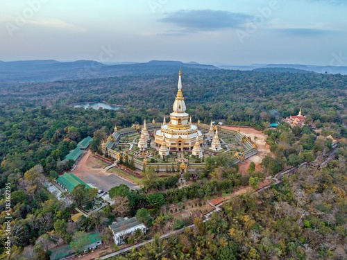 Aerial view landmark : " Pra Maha Chedi Chai Mongkhol Temple " at sunset sky. beautiful public landmark of Roi-Et Province, Thailand. 