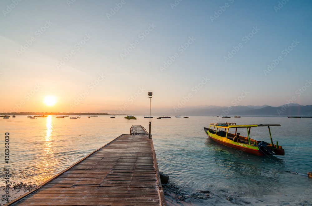 Fototapeta premium Beautiful sunrise at Gili Trawangan, or simply Gili T, is the largest of the three Gili Islands off Lombok. The island is one of the diving paradise in Indonesia.