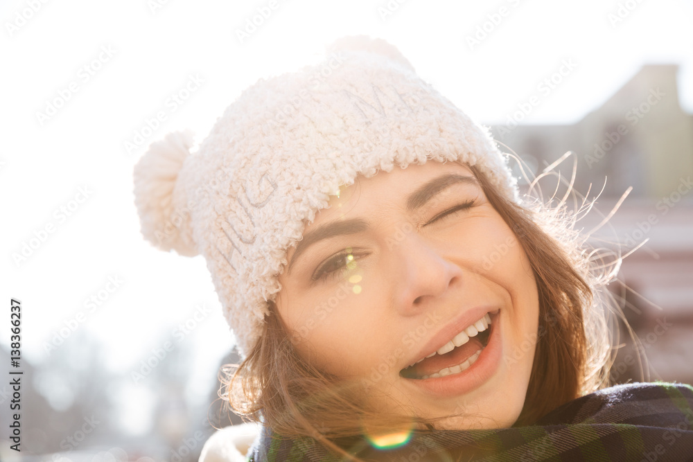 Happy young woman walking on the street
