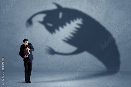 Photos Business man afraid of his own shadow monster concept
