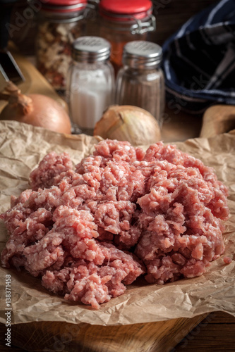 Minced meat on wooden background.