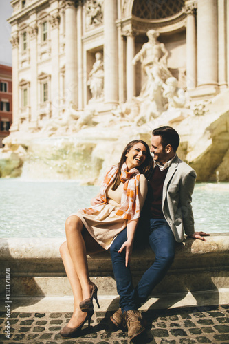 tourist couple on travel by Trevi Fountain in Rome, Italy.